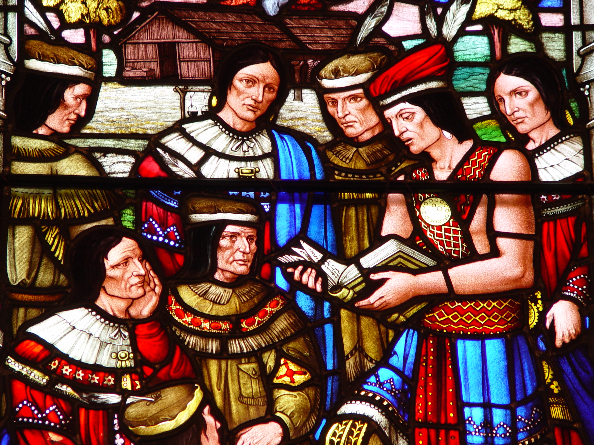 Stain glass depicting the Mohawk people reading the Gospel in community