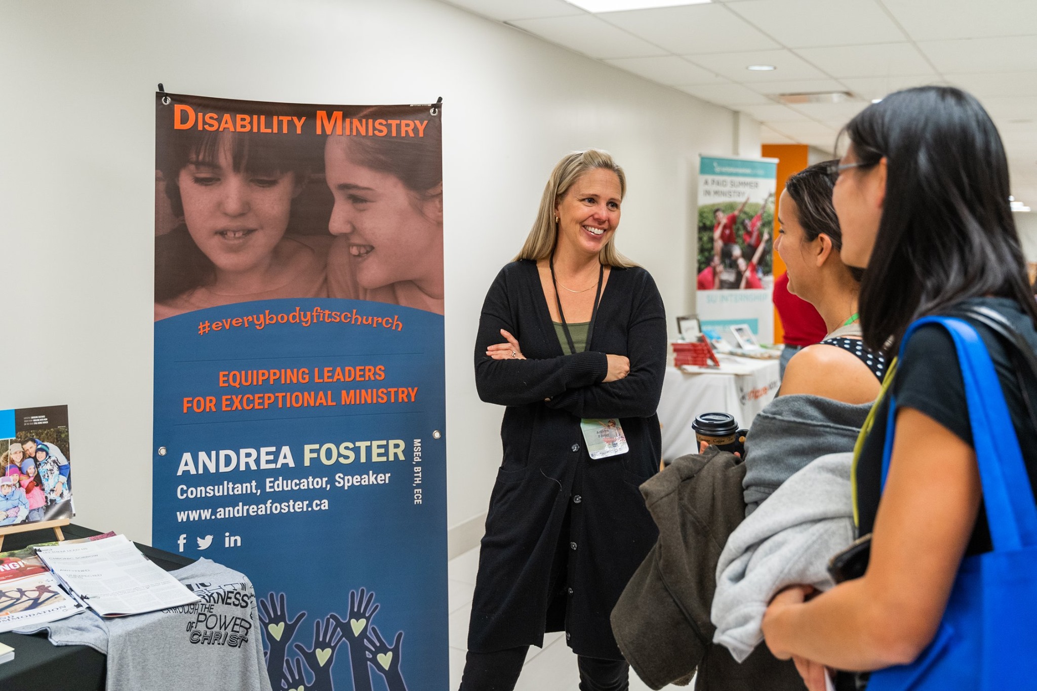 Andrea Foster talking with participants at the Disability ministry booth