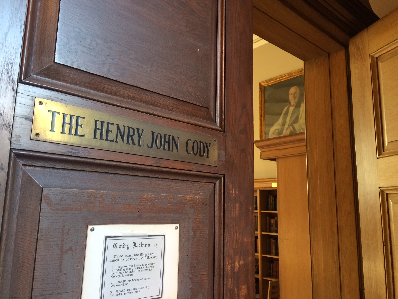 Dyson Hague's portrait is seen through the door of the Cody Library