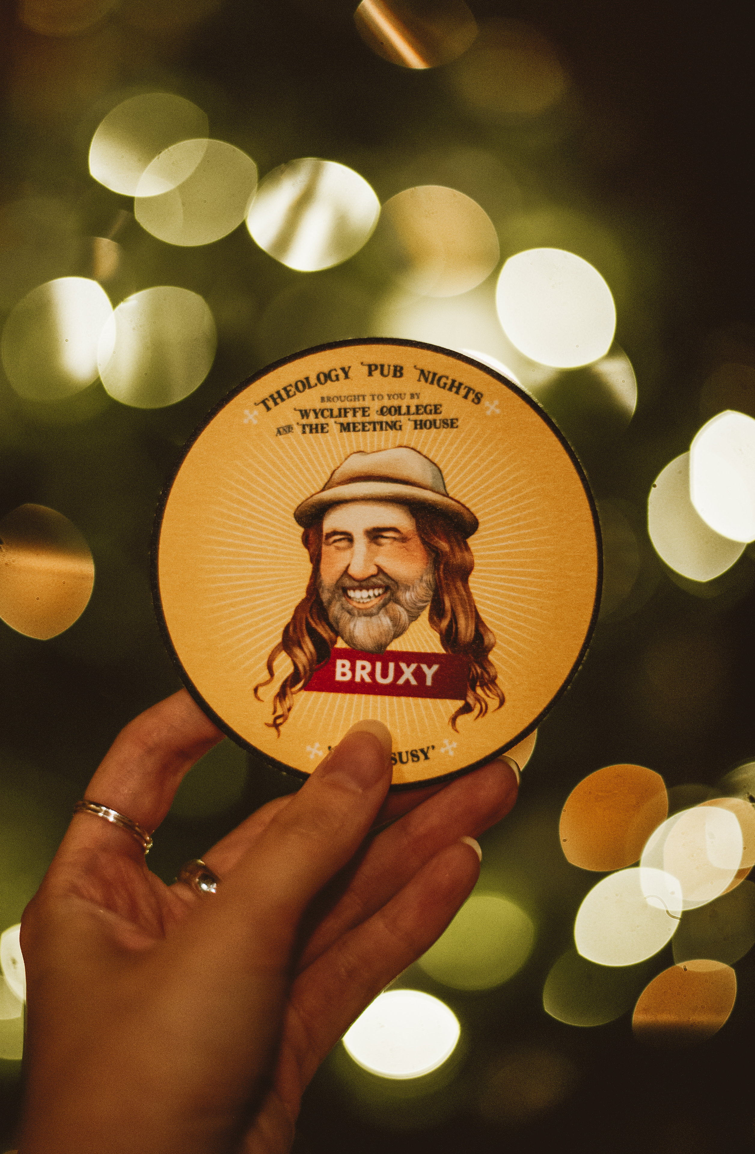 A coaster with an illustration of Bruxy Cavey