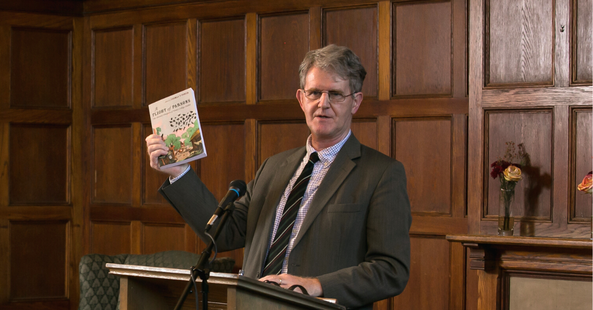 Thomas Power holding a book he authored