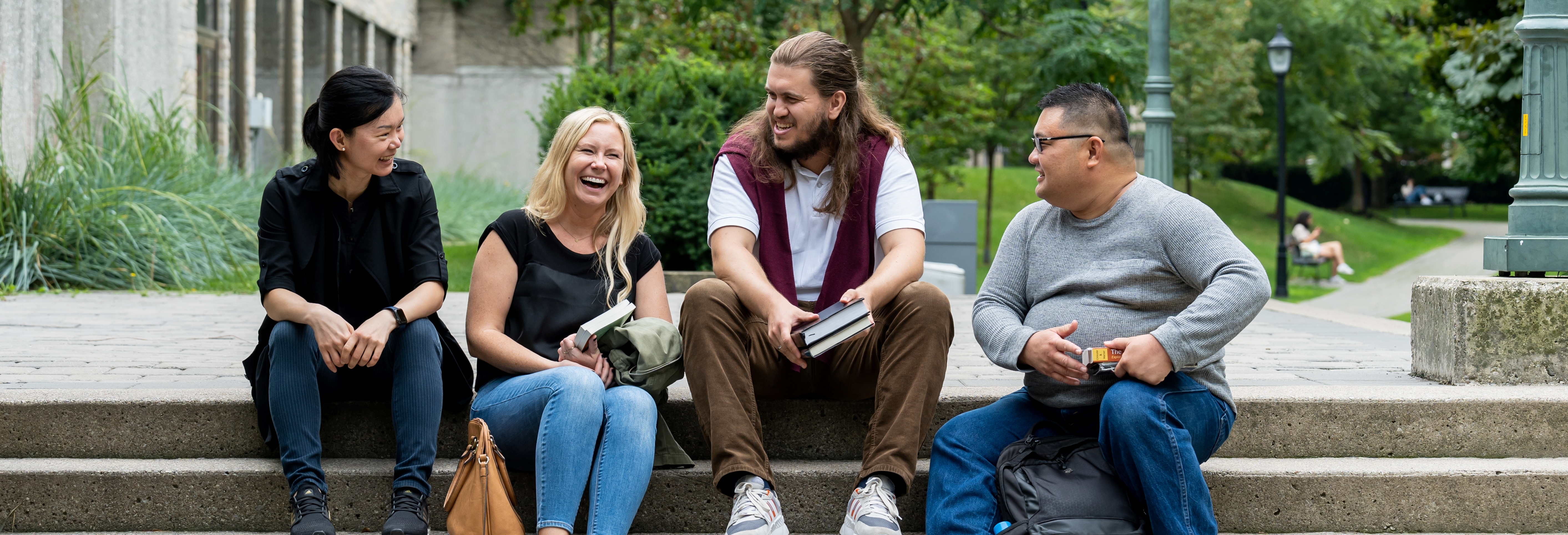 students sitting on steps outside