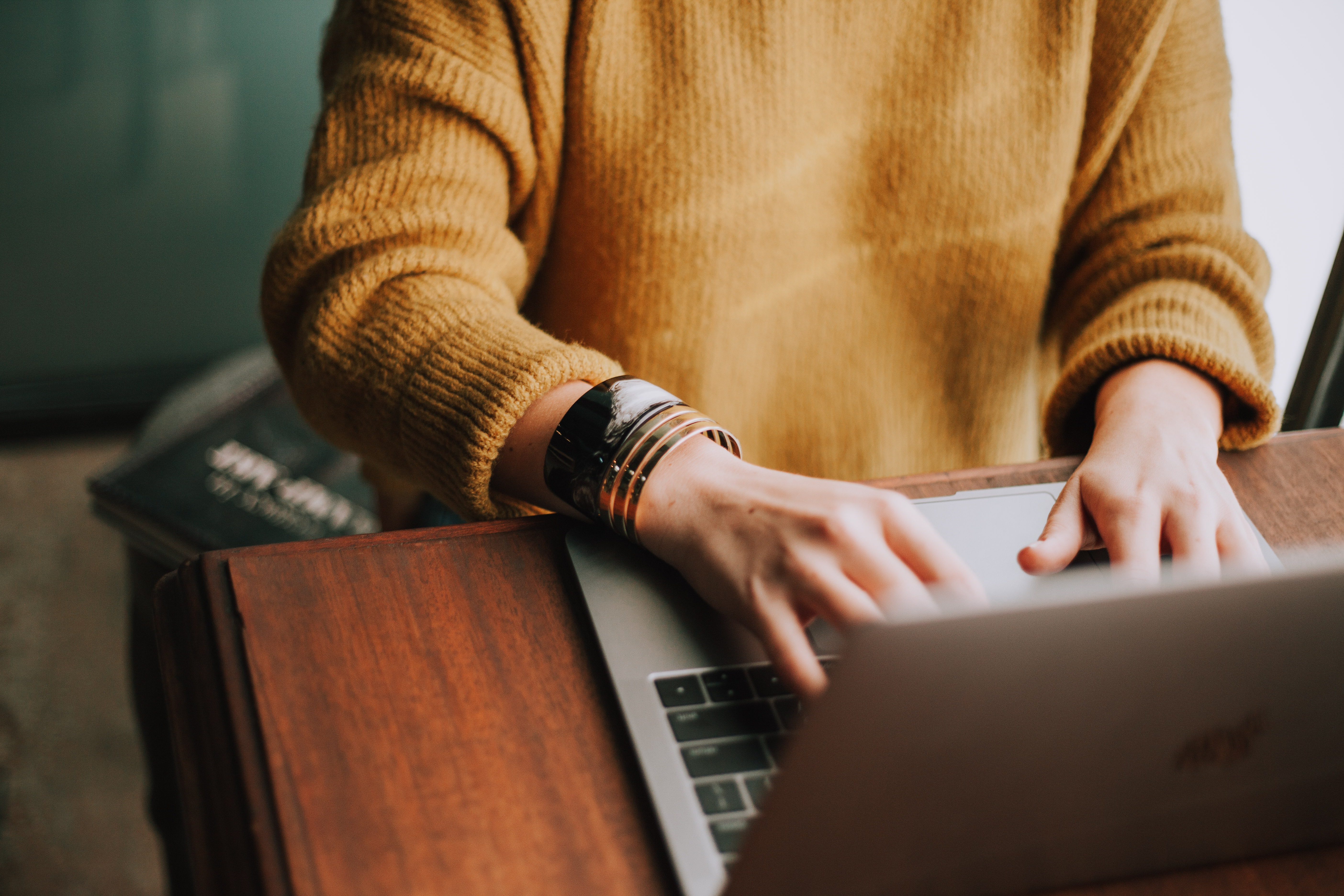 Photo by Christin Hume on Unsplash hands typing on laptop keyboard