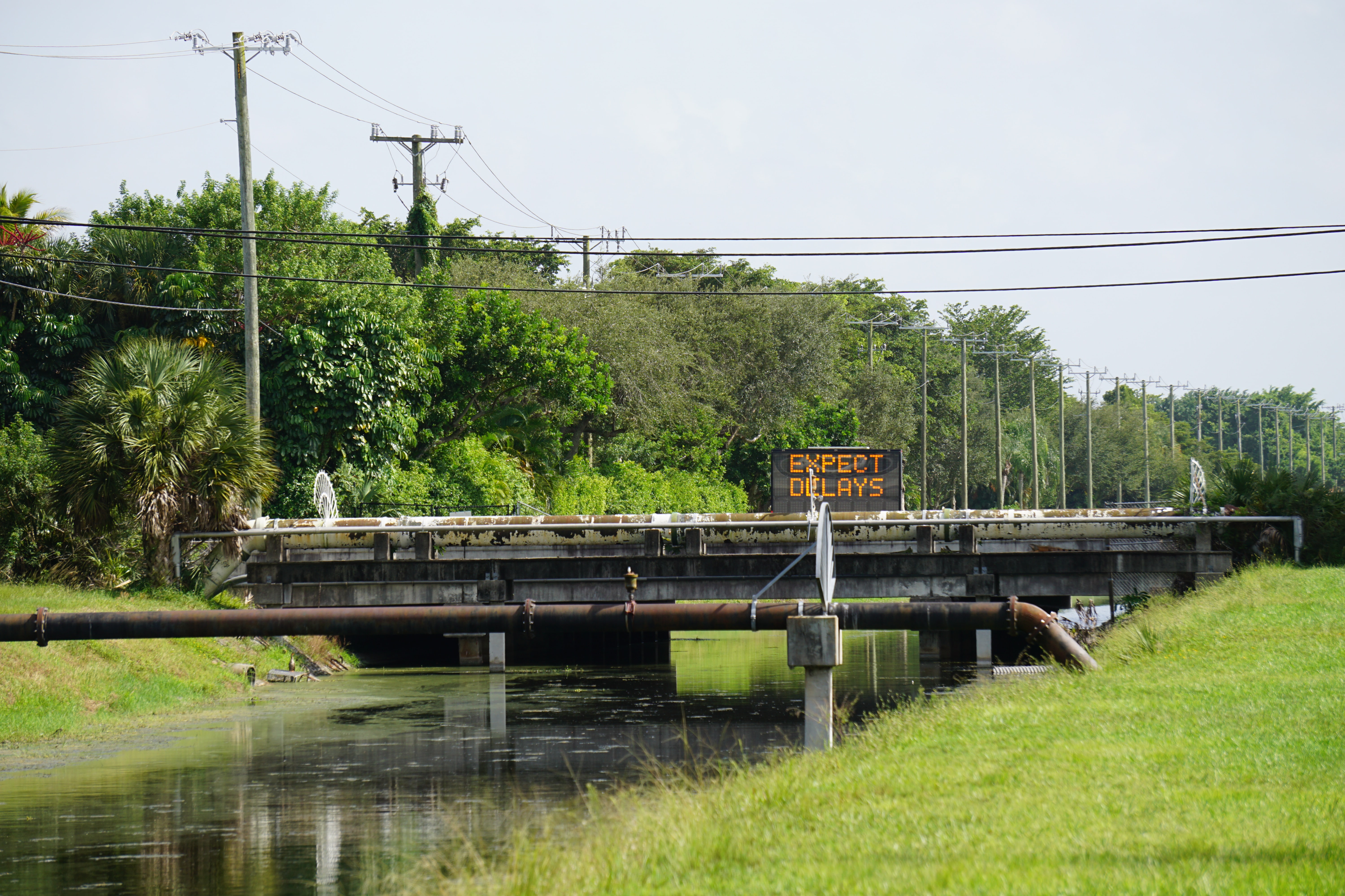 Outdoor scene with sign reading "Expect Delays" Outdoor scene with sign reading "Expect Delays"