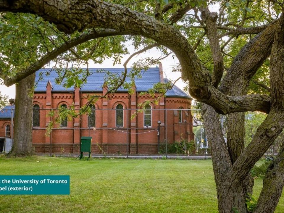 exterior photo of Chapel wall framed by the branches of tree that used to grow on lawn