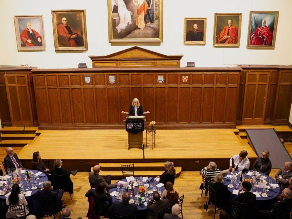 Principal Johnson speaking at podium in Sheraton Hall for Principal's Dinner 2025 