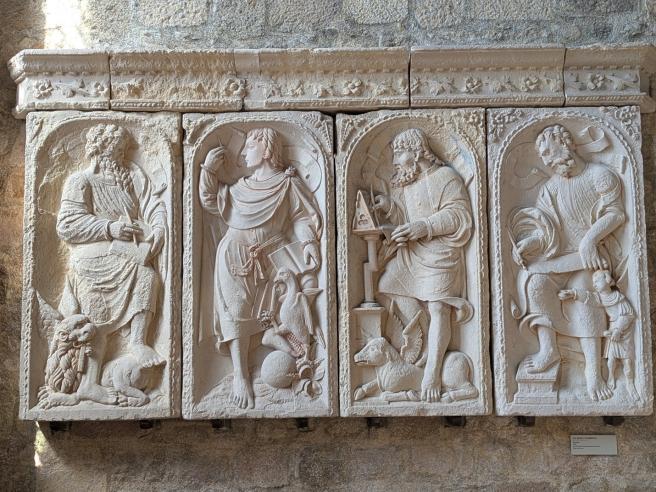 marble carving of Apostles bias-relief on church wall 