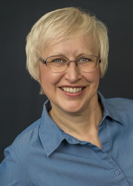headshot of Sheryl Grunwald in blue shirt 