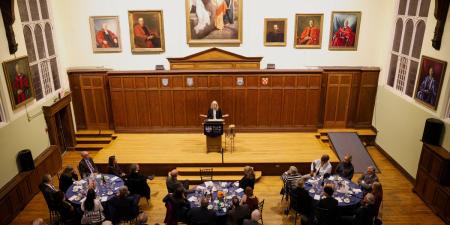 Principal Johnson speaking at podium in Sheraton Hall for Principal's Dinner 2025 