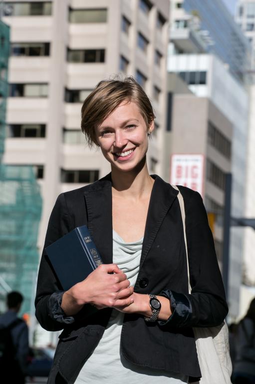 Courtney Reeve in jacket in front of city buildings