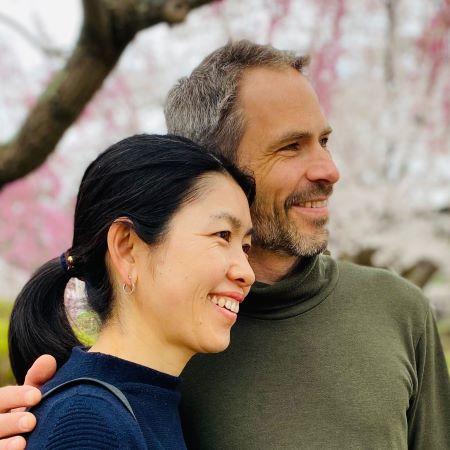 man and woman under trees with blossoms