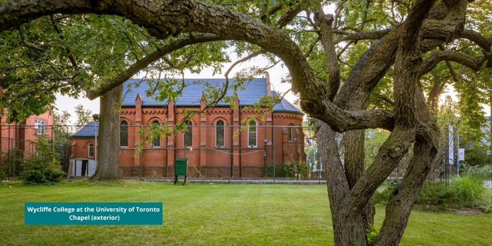exterior photo of Chapel wall framed by the branches of tree that used to grow on lawn
