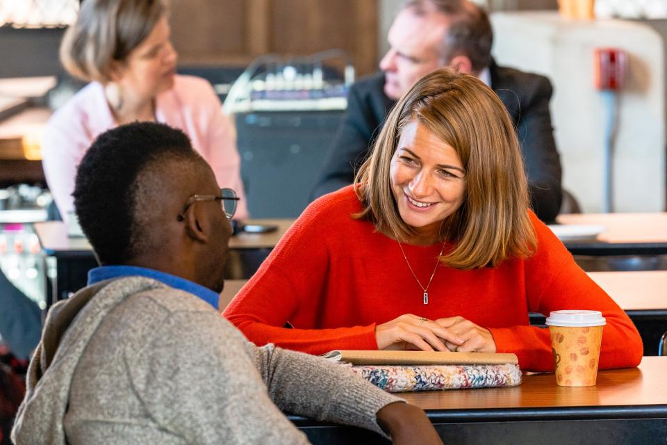 men and women in discussion at Wycliffe College
